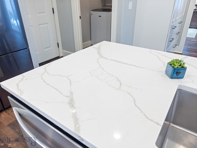 3171 Spring Ridge Dr, Bozeman, MT 59715 - bedroom with washer / clothes dryer, freestanding refrigerator, and dark wood-style flooring