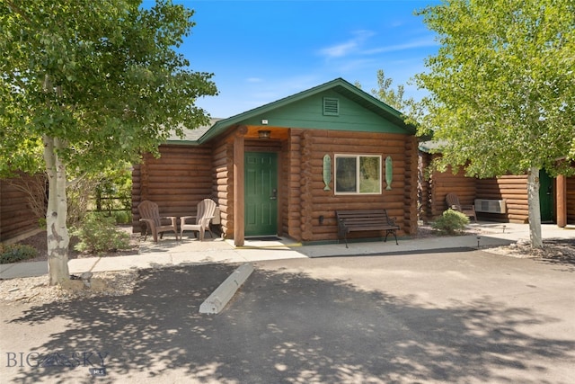 701 Bauer Ln Unit 2, Ennis, MT 59729 - view of front of house with log siding and a patio