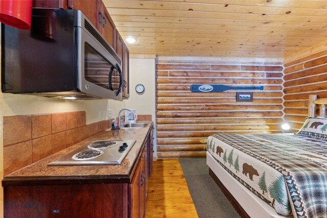 701 Bauer Ln Unit 2, Ennis, MT 59729 - bedroom featuring log walls, a sink, wooden ceiling, and light wood-style floors