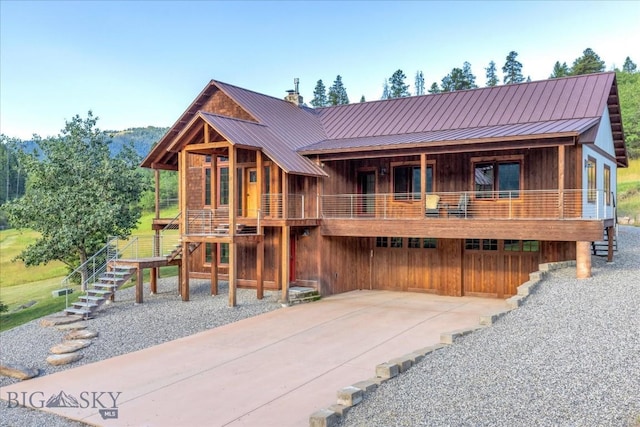 3011 Goose Creek Rd, Bozeman, MT 59715 - rustic home featuring stairway, board and batten siding, and metal roof