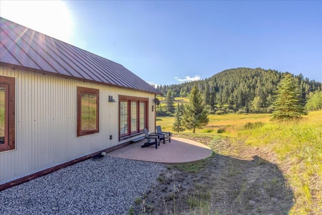 3011 Goose Creek Rd, Bozeman, MT 59715 - view of yard featuring french doors, a patio, a forest view, and a mountain view