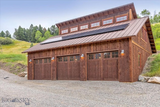 3011 Goose Creek Rd, Bozeman, MT 59715 - garage with a garage, roof mounted solar panels, and driveway