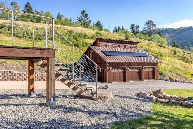3011 Goose Creek Rd, Bozeman, MT 59715 - view of front of house featuring an outbuilding, an exterior structure, a standing seam roof, metal roof, and a detached garage