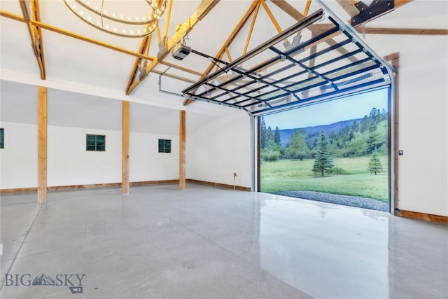 3011 Goose Creek Rd, Bozeman, MT 59715 - garage featuring a garage door opener, a mountain view, and baseboards