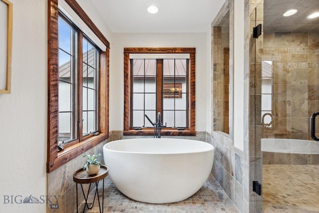 3011 Goose Creek Rd, Bozeman, MT 59715 - bathroom featuring tile walls, a soaking tub, a stall shower, wainscoting, and recessed lighting