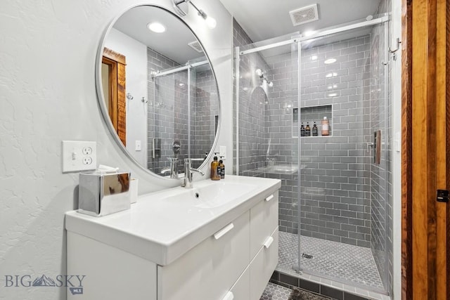 3011 Goose Creek Rd, Bozeman, MT 59715 - bathroom with a textured wall, vanity, and a shower stall