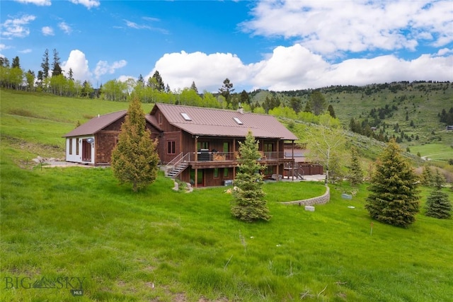 3011 Goose Creek Rd, Bozeman, MT 59715 - back of property featuring a wooden deck, stairs, a yard, and metal roof