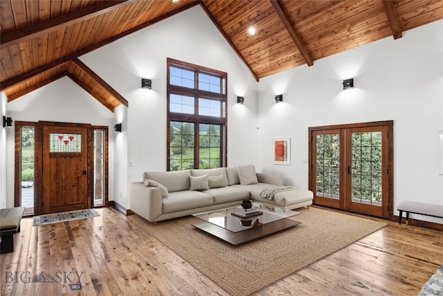 3011 Goose Creek Rd, Bozeman, MT 59715 - living area featuring wood ceiling with exposed beams, wood finished floors, high vaulted ceiling, healthy amount of natural light, and baseboards
