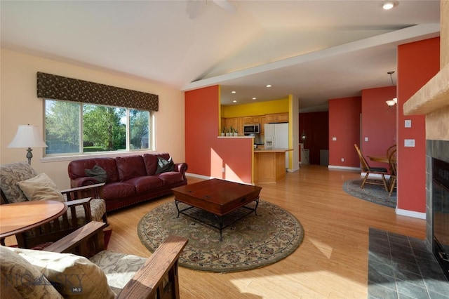 505 E Granite, Bozeman, MT 59718 - living area with a tiled fireplace, lofted ceiling, light wood-type flooring, and recessed lighting