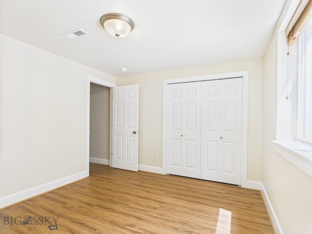3405 W Fieldstone Dr, Bozeman, MT 59715 - unfurnished bedroom featuring light wood-style floors, baseboards, and a closet
