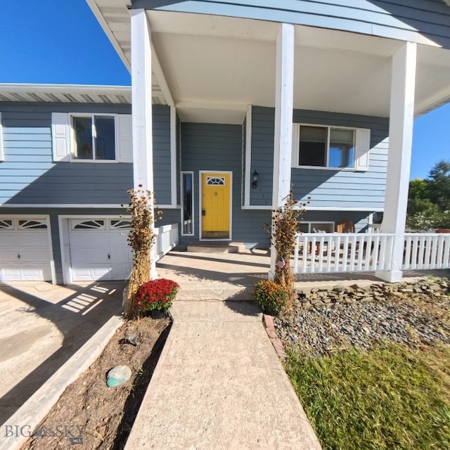 616 Comet, Livingston, MT 59047 - view of front of home featuring covered porch, an attached garage, and driveway