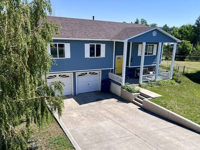 616 Comet, Livingston, MT 59047 - bi-level home with roof with shingles, covered porch, a garage, and concrete driveway