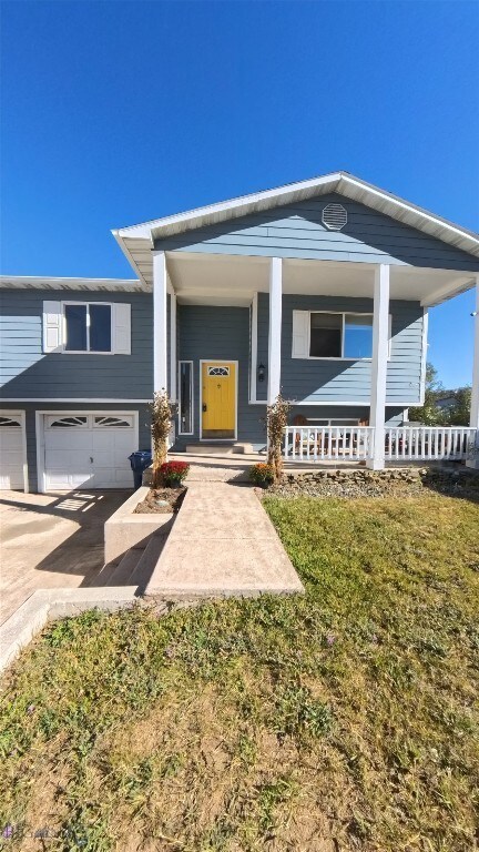 616 Comet, Livingston, MT 59047 - view of front of home featuring a garage, driveway, and a porch