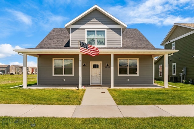 915 Arnold, Bozeman, MT 59715 - bungalow-style house with a porch, a front yard, central air condition unit, and roof with shingles