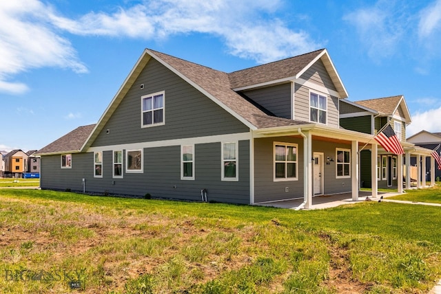 915 Arnold, Bozeman, MT 59715 - back of property featuring a shingled roof, a patio, and a yard