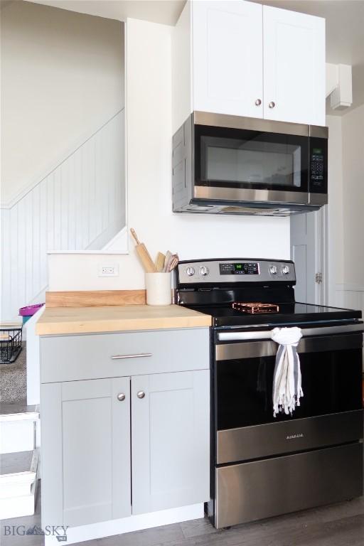 1905 Florence Ave, Butte, MT 59701 - kitchen with appliances with stainless steel finishes, white cabinetry, light countertops, and wood finished floors