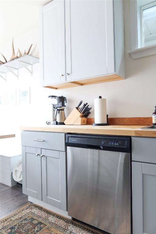 1905 Florence Ave, Butte, MT 59701 - kitchen featuring dishwasher, light countertops, white cabinetry, and wood finished floors