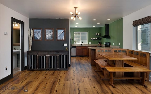 3650 Potosi St, Bozeman, MT 59718 - kitchen featuring wall chimney range hood, a sink, a chandelier, wood finished floors, and black / electric stove