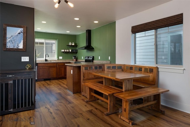 3650 Potosi St, Bozeman, MT 59718 - kitchen featuring wall chimney range hood, range with electric cooktop, a sink, wood finished floors, and recessed lighting