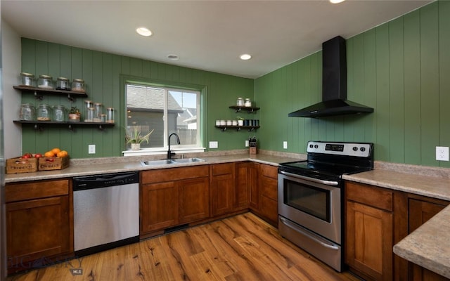 3650 Potosi St, Bozeman, MT 59718 - kitchen with appliances with stainless steel finishes, a sink, wall chimney range hood, open shelves, and light wood-style flooring