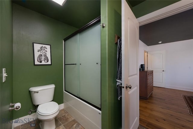 3650 Potosi St, Bozeman, MT 59718 - bathroom with toilet, shower / bath combination with glass door, baseboards, and wood finished floors