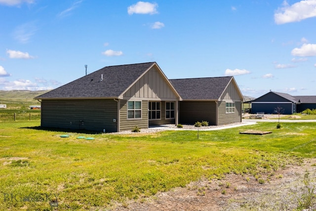 30 Blue Stem Way, Three Forks, MT 59752 - rear view of house featuring board and batten siding, a lawn, and roof with shingles