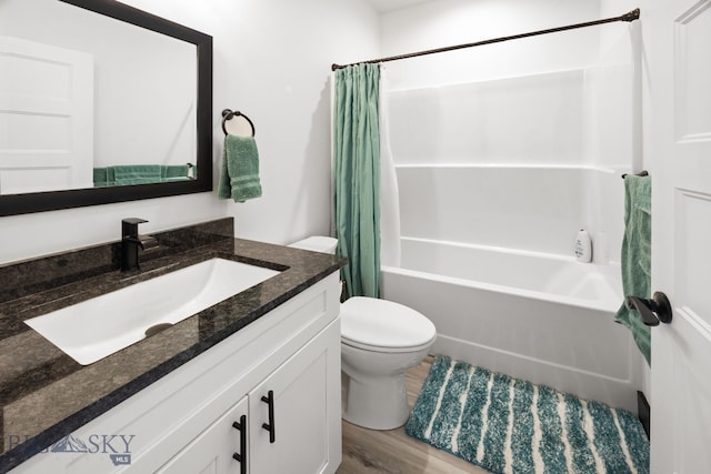 30 Blue Stem Way, Three Forks, MT 59752 - bathroom featuring vanity, toilet, shower / bathtub combination with curtain, and wood finished floors