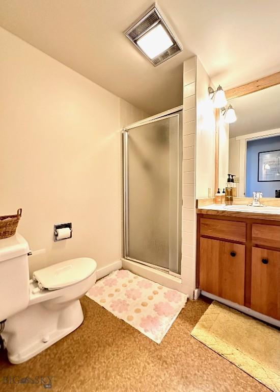 2225 Black Otter Rd Unit 23, Big Sky, MT 59716 - full bath featuring toilet, vanity, a shower stall, and baseboards