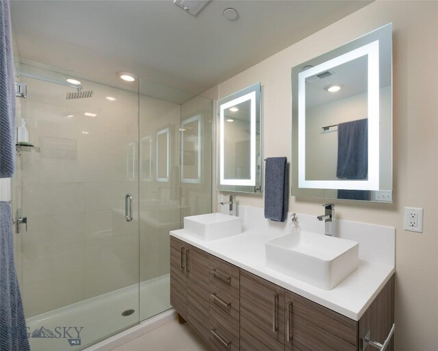 476 Enterprise Blvd Unit 207, Bozeman, MT 59718 - bathroom featuring a stall shower, double vanity, and recessed lighting