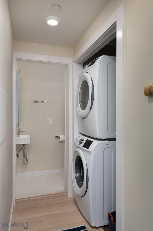 476 Enterprise Blvd Unit 207, Bozeman, MT 59718 - washroom with estacked washer and dryer and light wood-style flooring