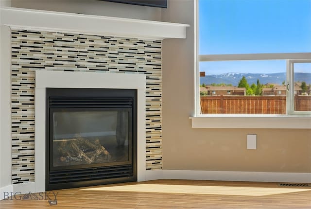 110 Ramshorn Peak Ln, Bozeman, MT 59718 - detailed view of a mountainous background, wood finished floors, and a tile fireplace