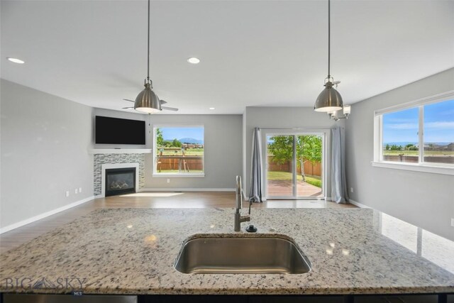 110 Ramshorn Peak Ln, Bozeman, MT 59718 - kitchen featuring a sink, open floor plan, wood finished floors, pendant lighting, and recessed lighting