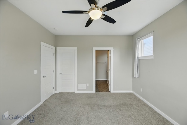 110 Ramshorn Peak Ln, Bozeman, MT 59718 - unfurnished bedroom featuring carpet floors, baseboards, ceiling fan, and a spacious closet