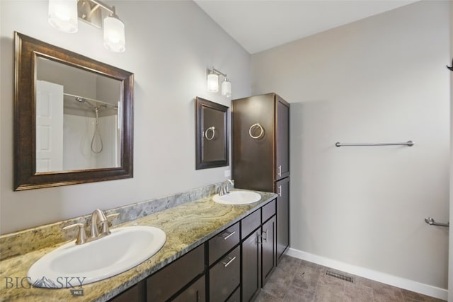 110 Ramshorn Peak Ln, Bozeman, MT 59718 - full bathroom featuring baseboards, double vanity, and a shower