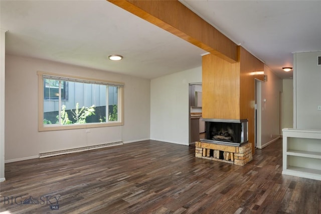 1109 S Willson, Bozeman, MT 59715 - unfurnished living room featuring a baseboard radiator, dark wood finished floors, a fireplace with raised hearth, and baseboards