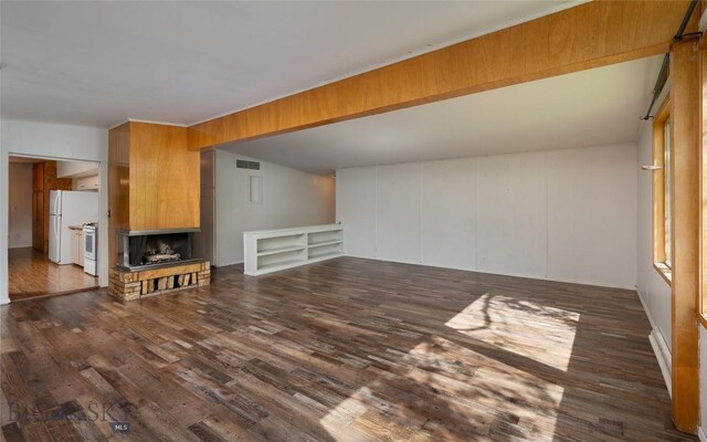 1109 S Willson, Bozeman, MT 59715 - unfurnished living room featuring dark wood-type flooring and a fireplace