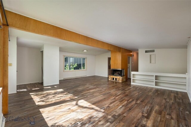 1109 S Willson, Bozeman, MT 59715 - unfurnished living room featuring dark wood-type flooring and baseboards