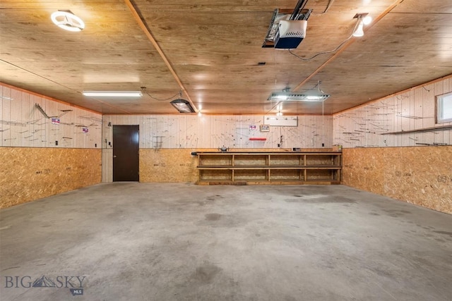 2105 Lincoln St, Anaconda, MT 59711 - garage featuring a workshop area, a garage door opener, and wood walls