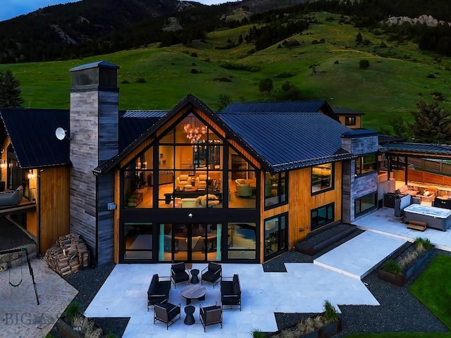 354 Brass Lantern Ct, Bozeman, MT 59715 - rear view of house with an outdoor living space, a mountain view, and a patio area