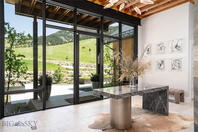 354 Brass Lantern Ct, Bozeman, MT 59715 - entryway featuring light tile patterned floors, a mountain view, and a wall of windows