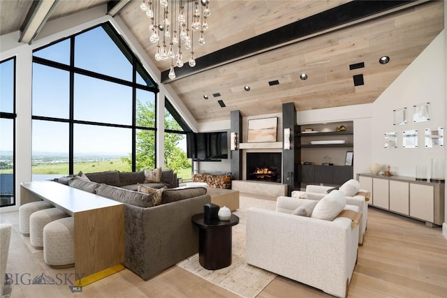 354 Brass Lantern Ct, Bozeman, MT 59715 - living room with high vaulted ceiling, light wood-style flooring, beam ceiling, a premium fireplace, and a chandelier
