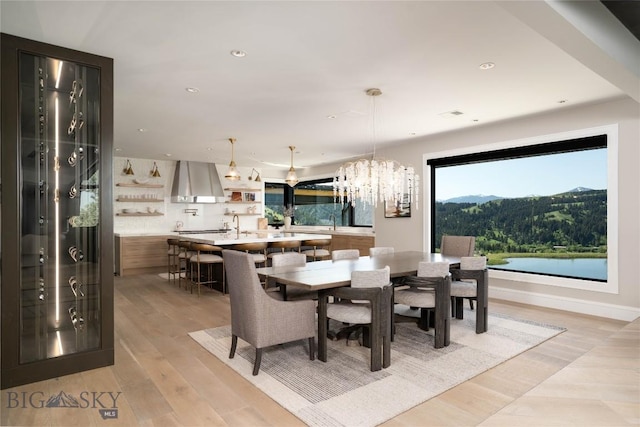 354 Brass Lantern Ct, Bozeman, MT 59715 - dining room with a chandelier, plenty of natural light, light wood finished floors, recessed lighting, and a mountain view