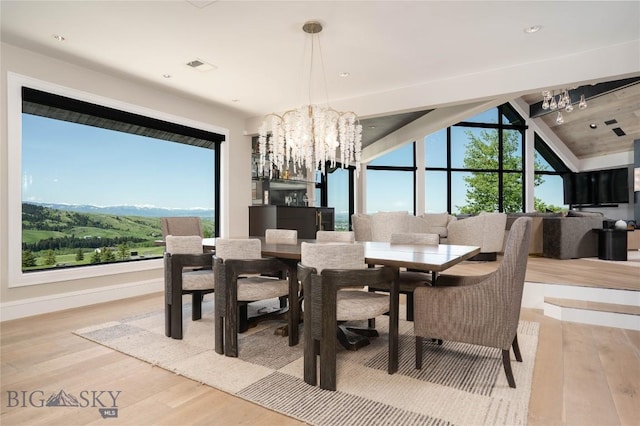 354 Brass Lantern Ct, Bozeman, MT 59715 - dining space featuring a chandelier, wood finished floors, plenty of natural light, vaulted ceiling, and recessed lighting