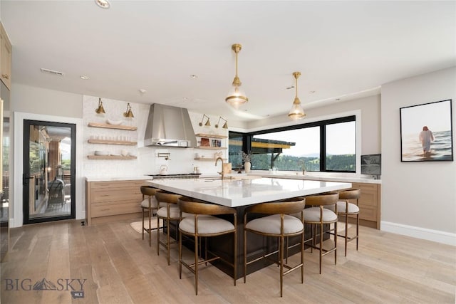 354 Brass Lantern Ct, Bozeman, MT 59715 - kitchen featuring open shelves, island exhaust hood, light countertops, light wood-style flooring, and recessed lighting