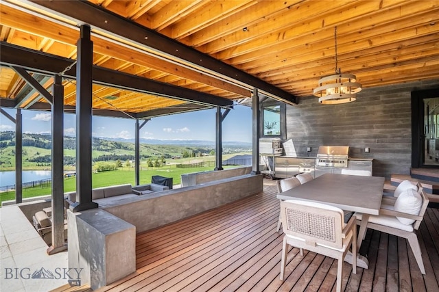 354 Brass Lantern Ct, Bozeman, MT 59715 - wooden deck featuring a water view and outdoor dining space