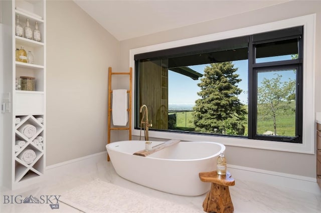 354 Brass Lantern Ct, Bozeman, MT 59715 - full bathroom with a freestanding bath, marble finish flooring, lofted ceiling, baseboards, and a sink