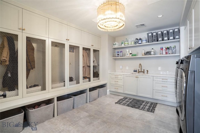 354 Brass Lantern Ct, Bozeman, MT 59715 - mudroom with washer and clothes dryer, wet bar, and a chandelier
