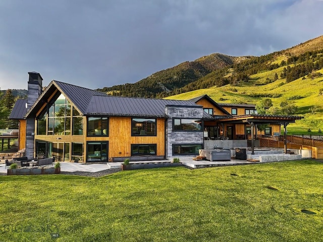 354 Brass Lantern Ct, Bozeman, MT 59715 - rear view of property with outdoor lounge area, a chimney, a patio, and a standing seam roof