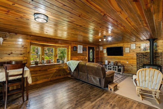 234 Mill Creek Rd, Sheridan, MT 59749 - living area with a wood stove, wooden ceiling, wood walls, and wood finished floors