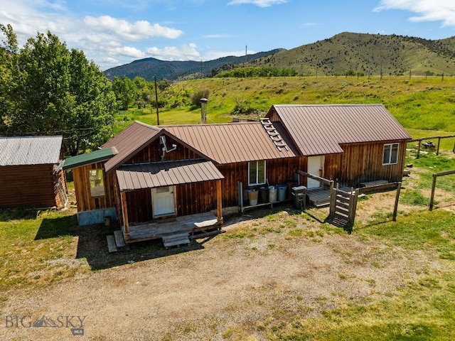 234 Mill Creek Rd, Sheridan, MT 59749 - view of front facade featuring a mountain view, metal roof, and board and batten siding